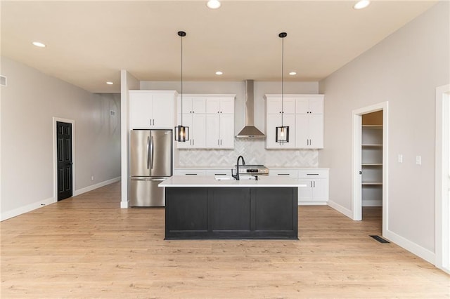 149 S Linn Valley Dr, Linn Valley, KS 66040 - kitchen with appliances with stainless steel finishes, wall chimney range hood, light countertops, backsplash, and white cabinets