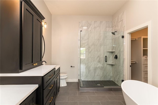 149 S Linn Valley Dr, Linn Valley, KS 66040 - bathroom featuring a shower stall, tile patterned flooring, a freestanding tub, vanity, and baseboards