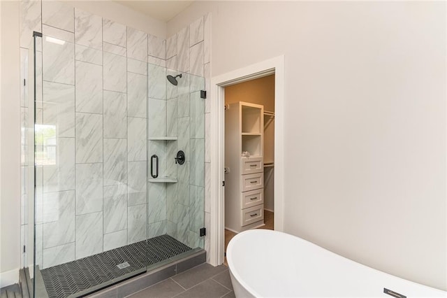 149 S Linn Valley Dr, Linn Valley, KS 66040 - full bath with a freestanding bath, a stall shower, a spacious closet, and tile patterned floors