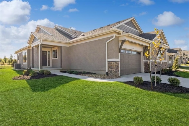 craftsman house with a front yard, cooling unit, and a garage