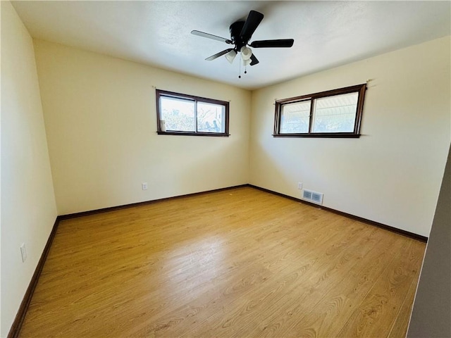 empty room featuring ceiling fan and light wood-type flooring