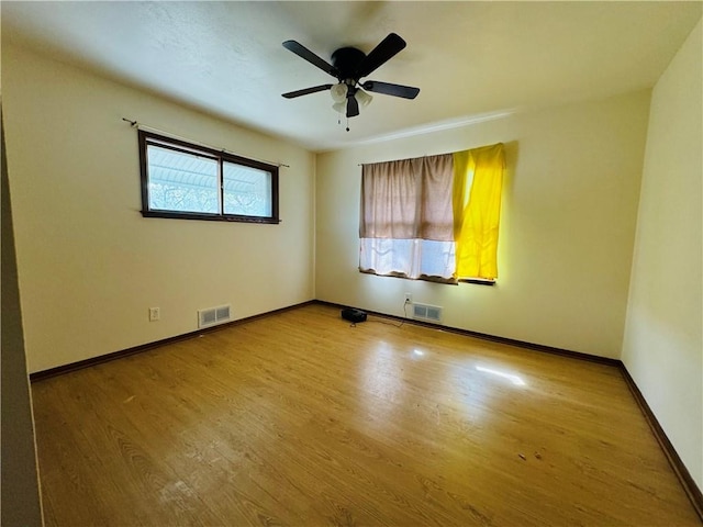 empty room with light hardwood / wood-style floors and ceiling fan