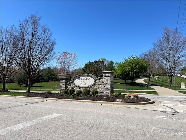 community / neighborhood sign with a lawn