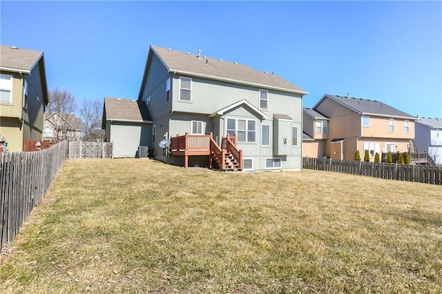 rear view of property with a yard, a fenced backyard, a residential view, and a wooden deck