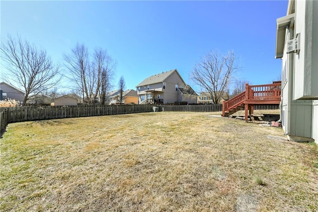 view of yard featuring a fenced backyard, stairway, and a wooden deck