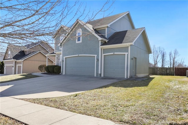 view of front of property featuring a garage, concrete driveway, stucco siding, fence, and a front yard