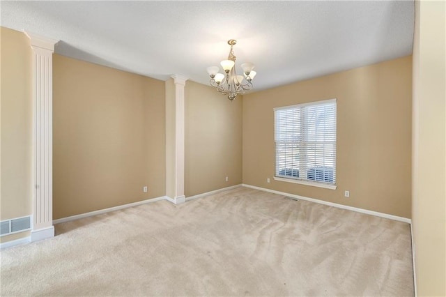 carpeted empty room featuring ornate columns, visible vents, baseboards, and an inviting chandelier