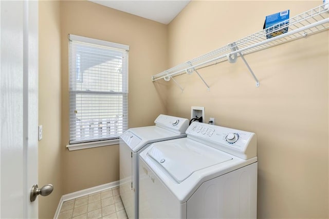 clothes washing area with laundry area, light tile patterned floors, baseboards, and washer and dryer