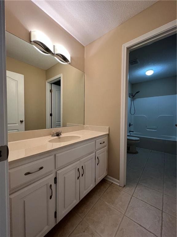 full bathroom with toilet, shower / tub combination, tile patterned floors, a textured ceiling, and vanity