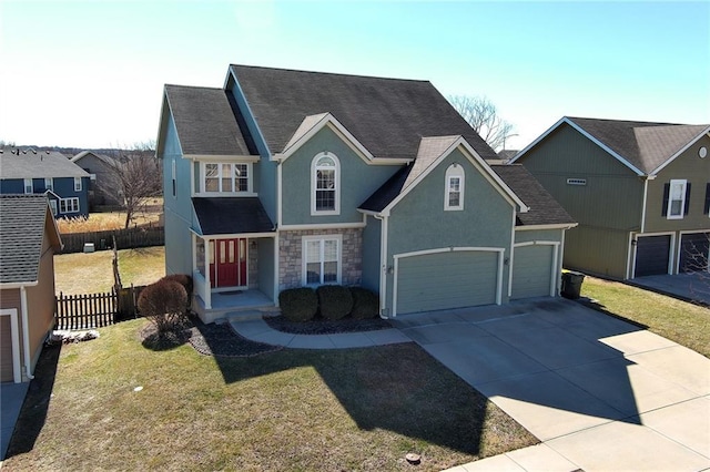 traditional-style home featuring fence, stone siding, concrete driveway, stucco siding, and a front yard