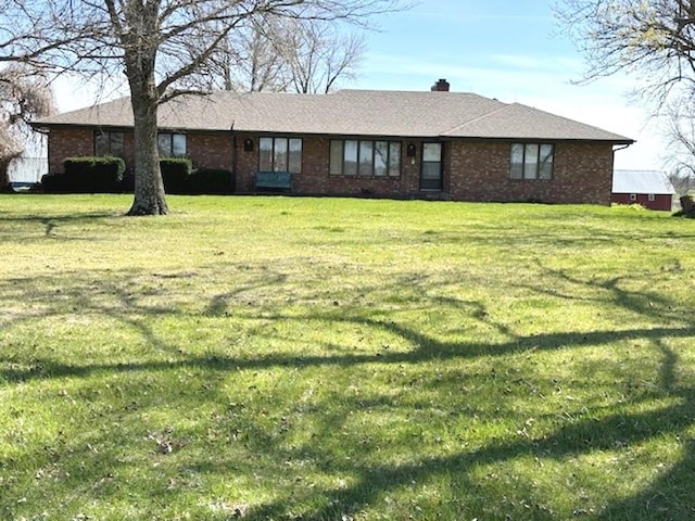 rear view of house with a yard