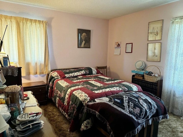 carpeted bedroom featuring a textured ceiling