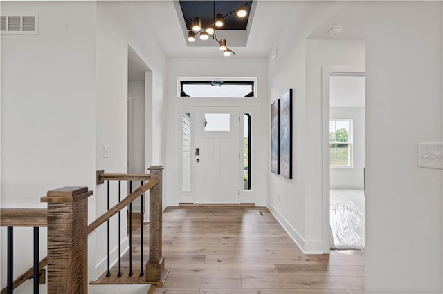 entrance foyer with light wood-type flooring, baseboards, and visible vents