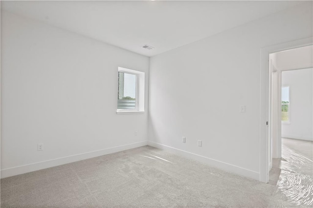 carpeted empty room featuring a healthy amount of sunlight