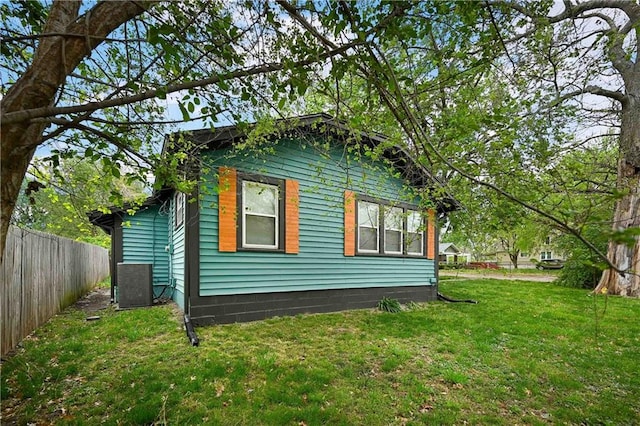 view of side of home featuring a yard