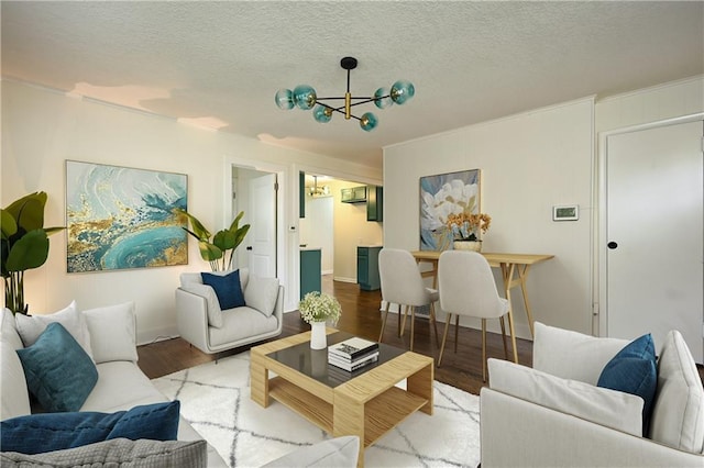 living room with light hardwood / wood-style floors, a chandelier, and a textured ceiling