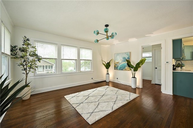 interior space with dark hardwood / wood-style flooring, a healthy amount of sunlight, and an inviting chandelier