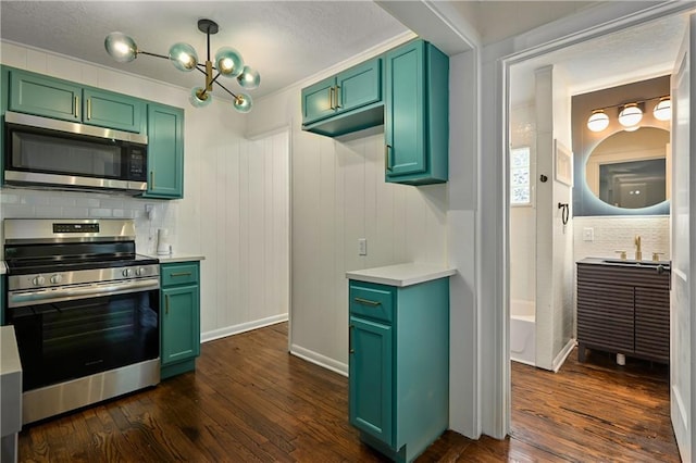 kitchen with dark hardwood / wood-style floors, green cabinetry, stainless steel appliances, and tasteful backsplash