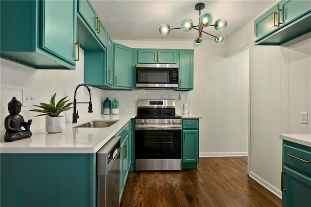 kitchen with dark hardwood / wood-style flooring, green cabinets, backsplash, appliances with stainless steel finishes, and sink