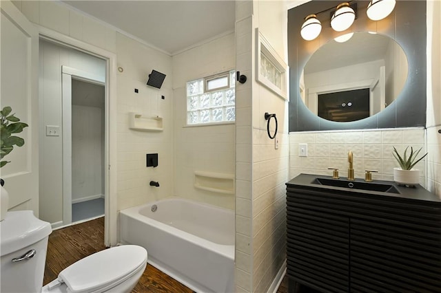 full bathroom featuring backsplash, toilet, ornamental molding,  shower combination, and hardwood / wood-style flooring