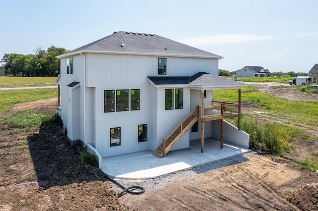 back of property featuring a patio and a deck