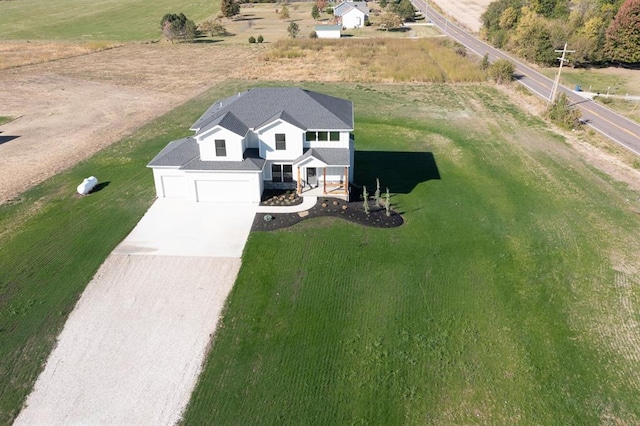 birds eye view of property with a rural view