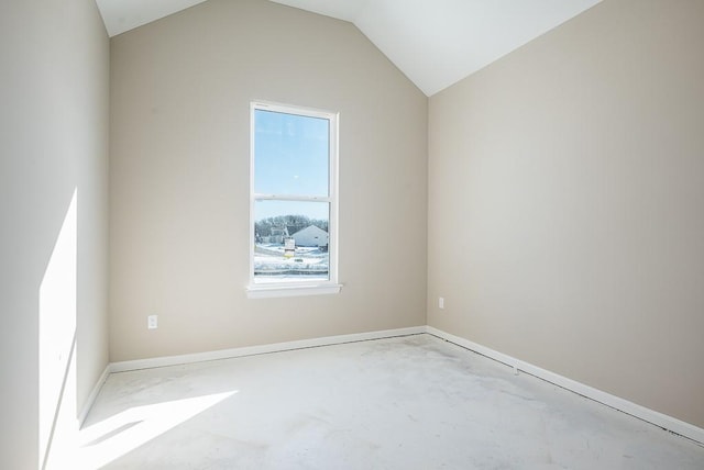 spare room featuring lofted ceiling