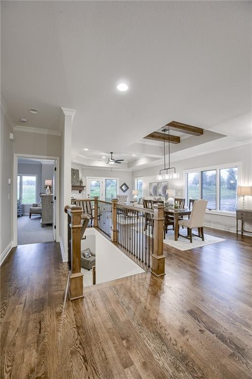 interior space with crown molding, hardwood / wood-style flooring, and ceiling fan