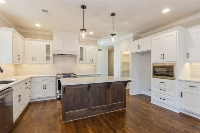 kitchen with dark hardwood / wood-style floors, white cabinets, and stainless steel appliances