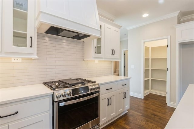 kitchen featuring gas range, premium range hood, white cabinetry, and dark hardwood / wood-style flooring