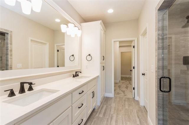 bathroom with vanity and a shower with shower door