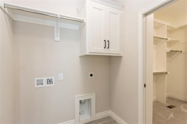 laundry area featuring light colored carpet, washer hookup, hookup for an electric dryer, and cabinets