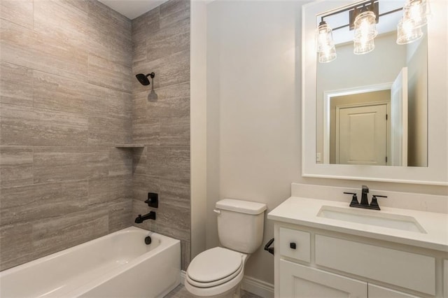 full bathroom with toilet, tiled shower / bath combo, and vanity