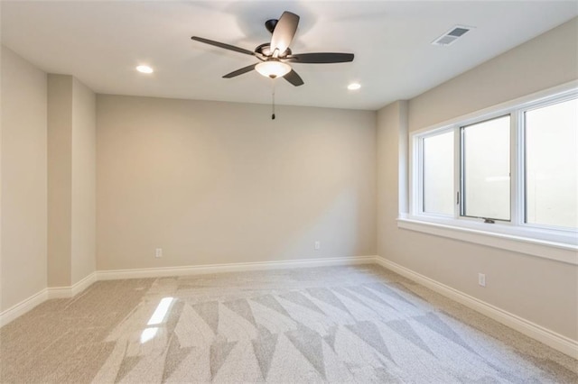 carpeted empty room featuring ceiling fan