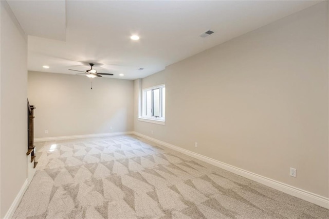 empty room featuring light carpet and ceiling fan