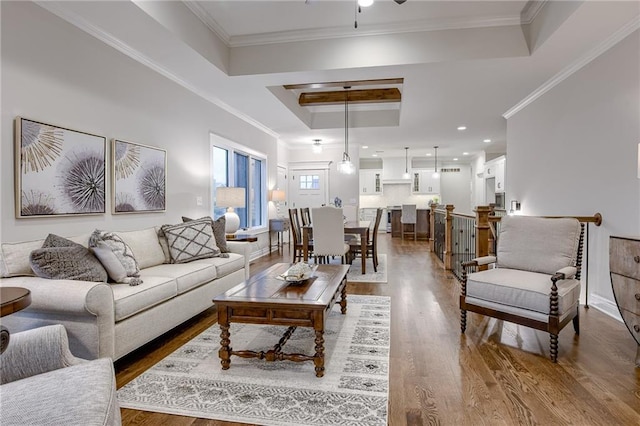 living room featuring ceiling fan, crown molding, a tray ceiling, and hardwood / wood-style floors