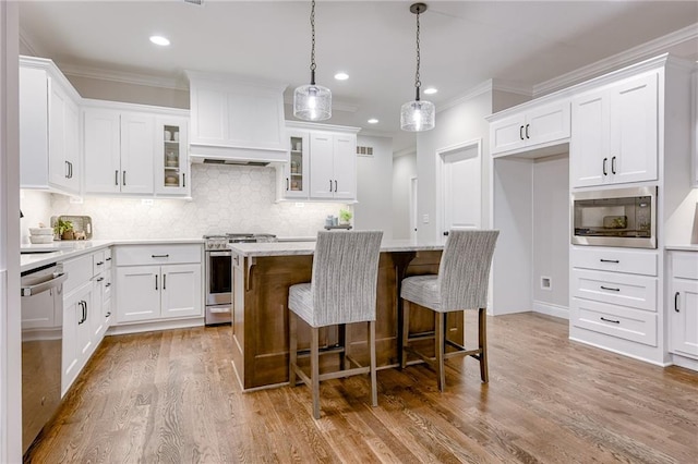 kitchen featuring a kitchen island, white cabinets, and stainless steel appliances