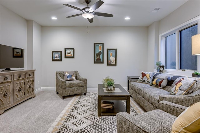 living room featuring light carpet and ceiling fan