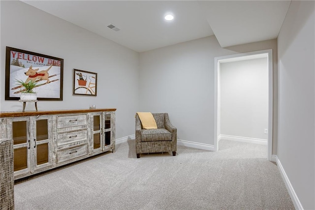 sitting room featuring light carpet