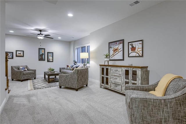 carpeted living room featuring ceiling fan