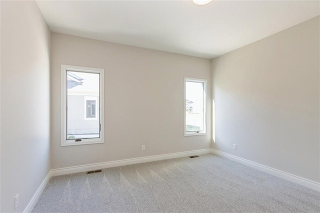 empty room featuring light carpet