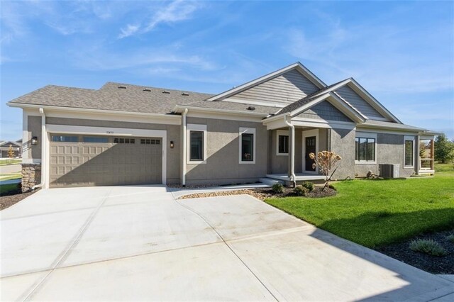 view of front facade featuring cooling unit, a front lawn, and a garage