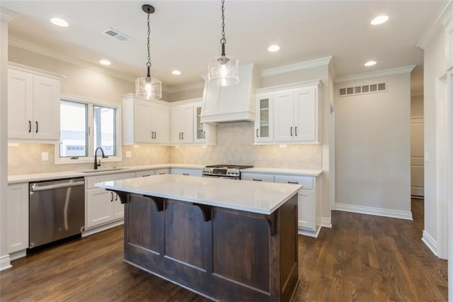 kitchen with white cabinetry, a center island, appliances with stainless steel finishes, and dark hardwood / wood-style flooring