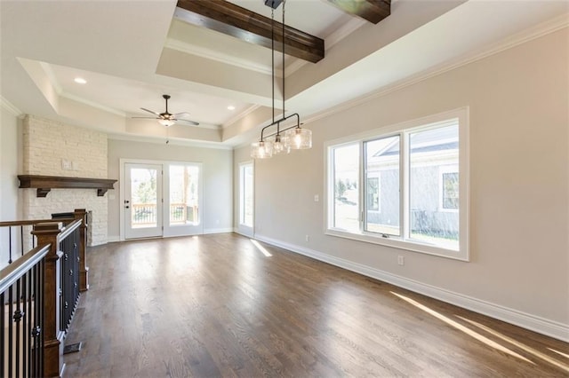 interior space with crown molding, ceiling fan, a raised ceiling, and dark hardwood / wood-style flooring