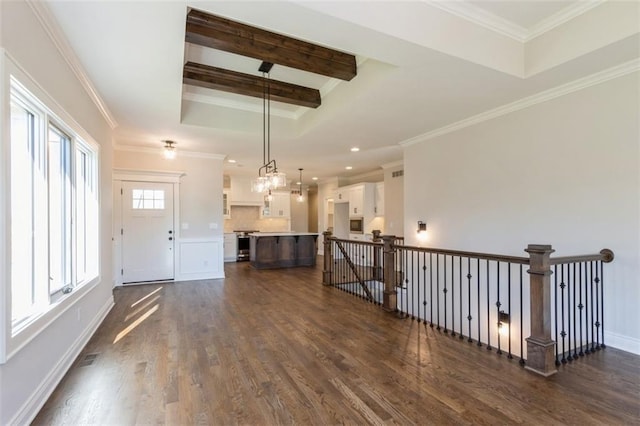 interior space with beam ceiling, ornamental molding, a chandelier, and dark hardwood / wood-style flooring