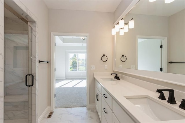 bathroom with a shower with door and vanity