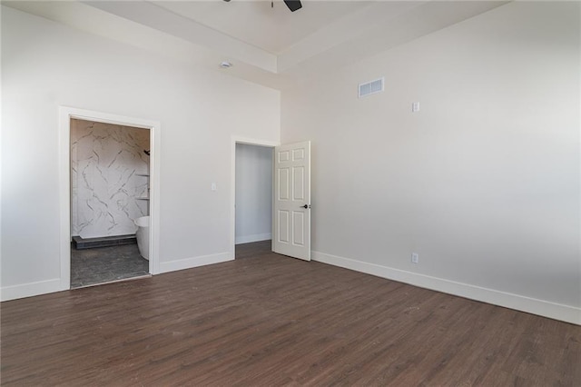 unfurnished bedroom with baseboards, visible vents, and dark wood-style flooring