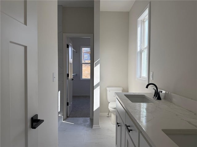 bathroom featuring vanity and toilet