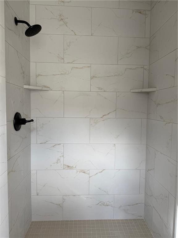 bathroom with a tile shower