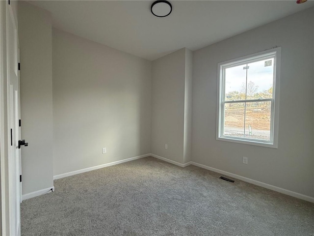 unfurnished room featuring light colored carpet